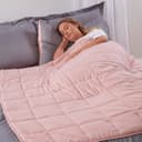 Pink Brentfords weighted blanket with quilted square pockets on a bed