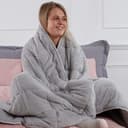 Silver grey Brentfords teddy fleece weighted blanket on a sofa